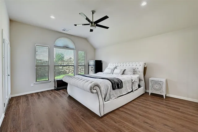 a bedroom with a large bed and a large window