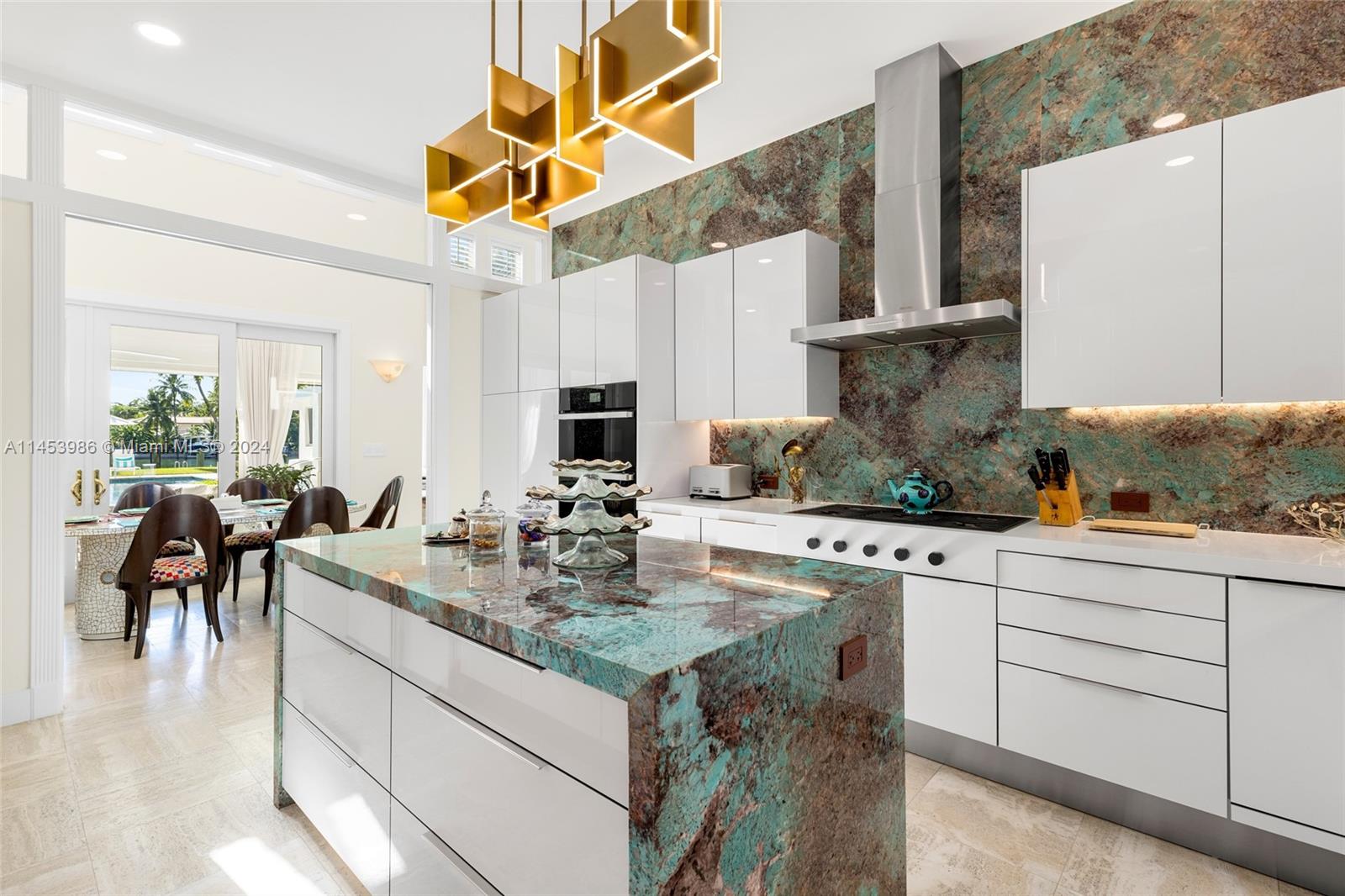 6350 Allison Road Miami Beach, FL 33141 - Photo 15 of 57 a kitchen with stainless steel appliances granite countertop a sink a stove and cabinets