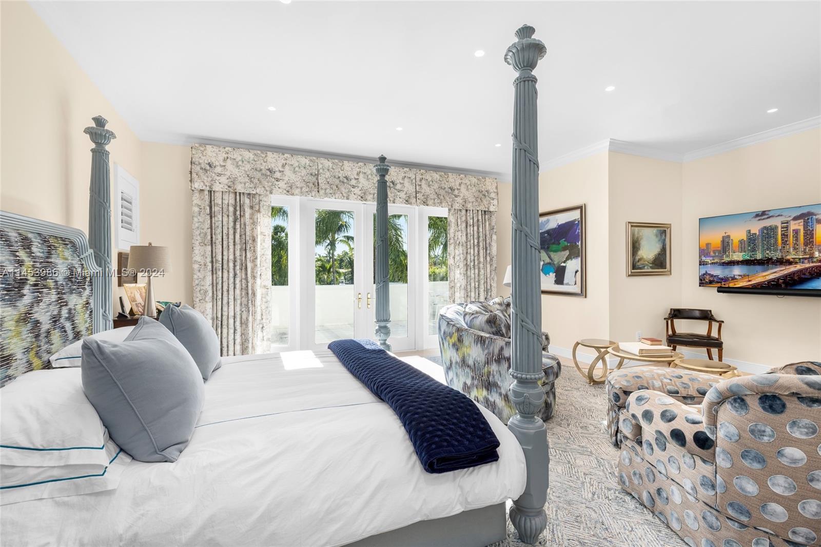 6350 Allison Road Miami Beach, FL 33141 - Photo 19 of 57 a bedroom with a large bed and a chandelier