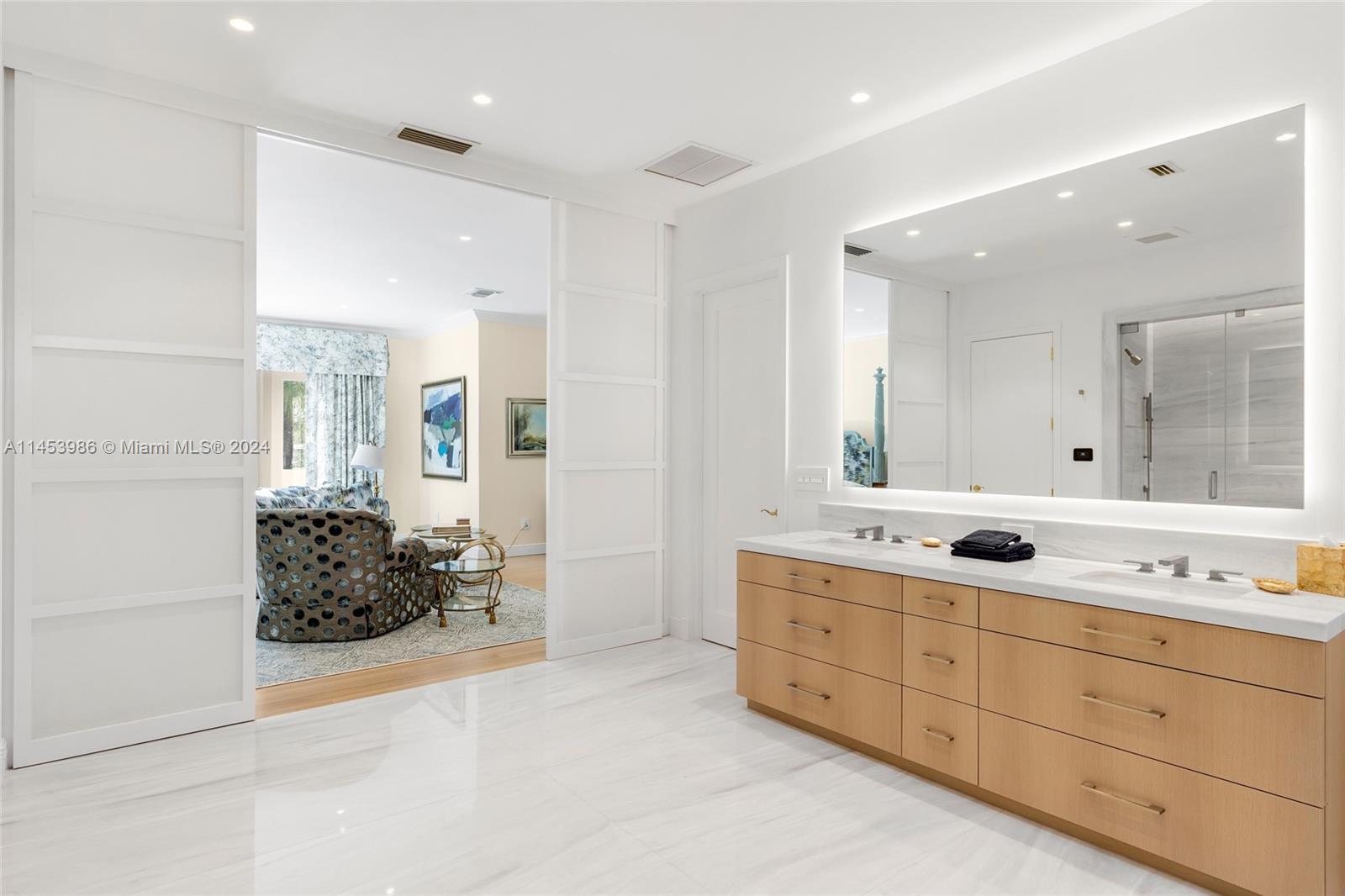 6350 Allison Road Miami Beach, FL 33141 - Photo 21 of 57 a bathroom with a double vanity sink mirror and