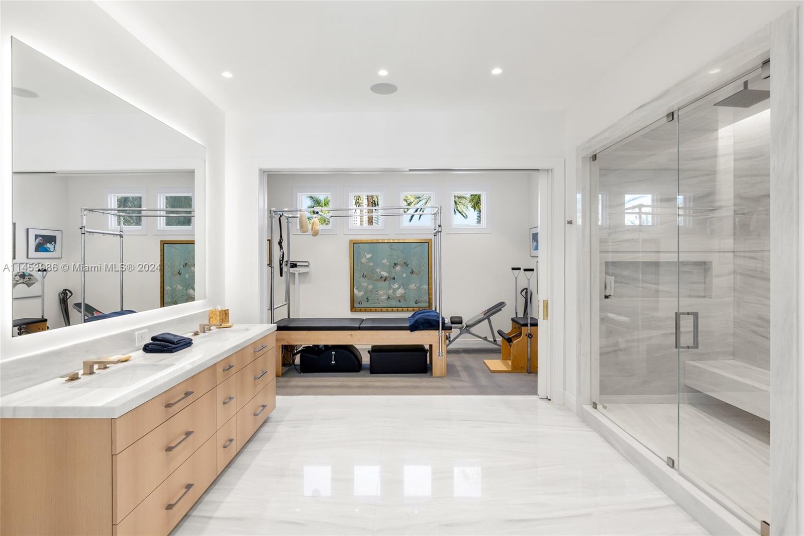 6350 Allison Road Miami Beach, FL 33141 - Photo 23 of 57 a large white bedroom with a bed and a large window