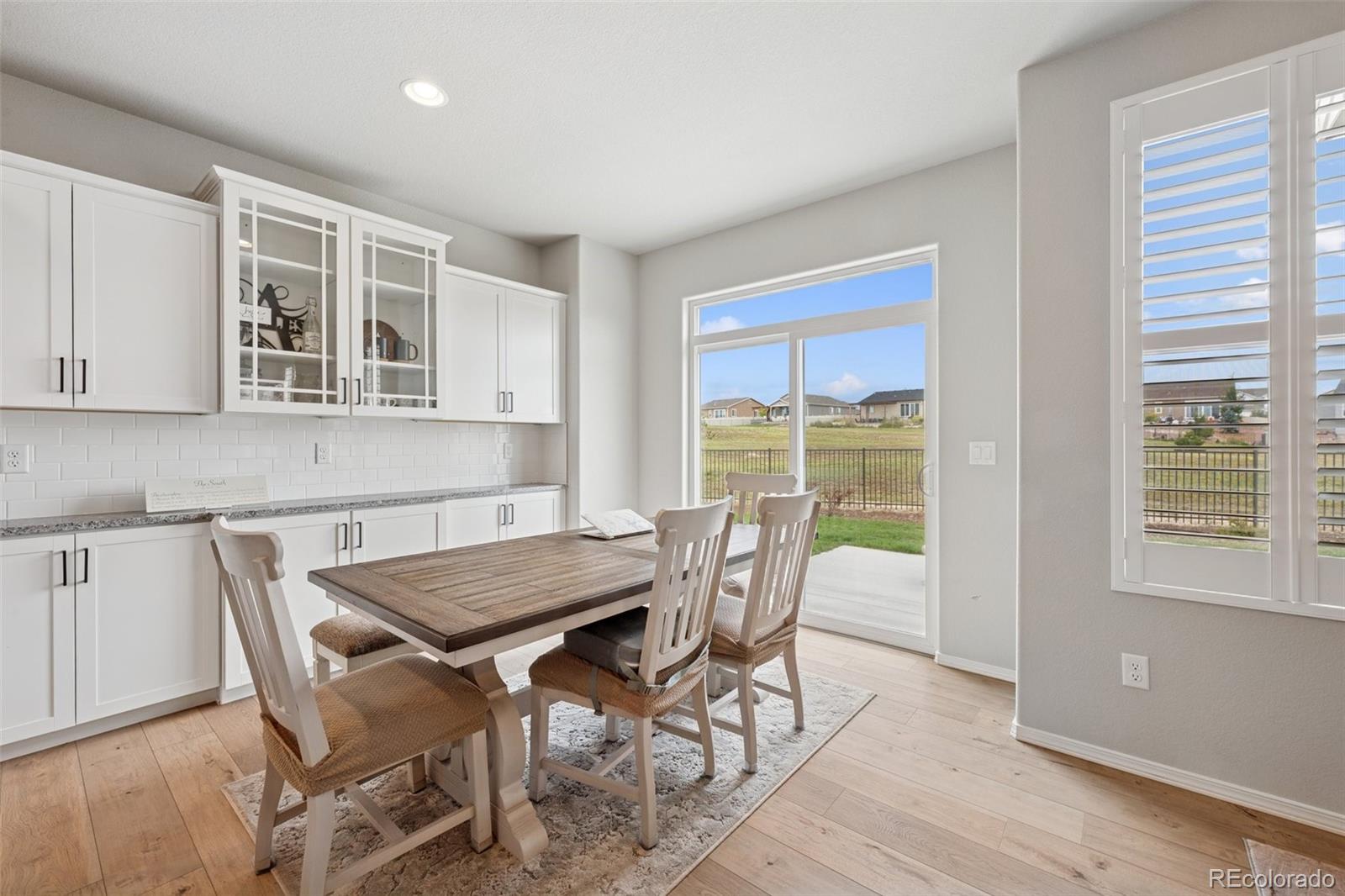 12846 Granite Ridge Drive Peyton, CO 80831 - Photo 11 of 32 a view of a dining room with furniture and wooden floor