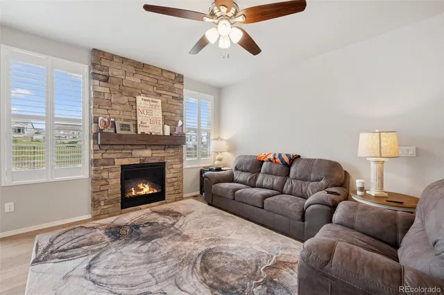 a living room with furniture and a ceiling fan