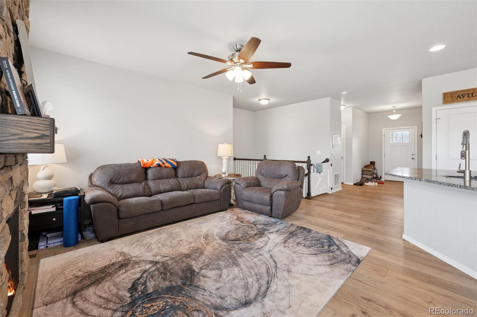 12846 Granite Ridge Drive Peyton, CO 80831 - Photo 16 of 32 a living room with furniture and a ceiling fan