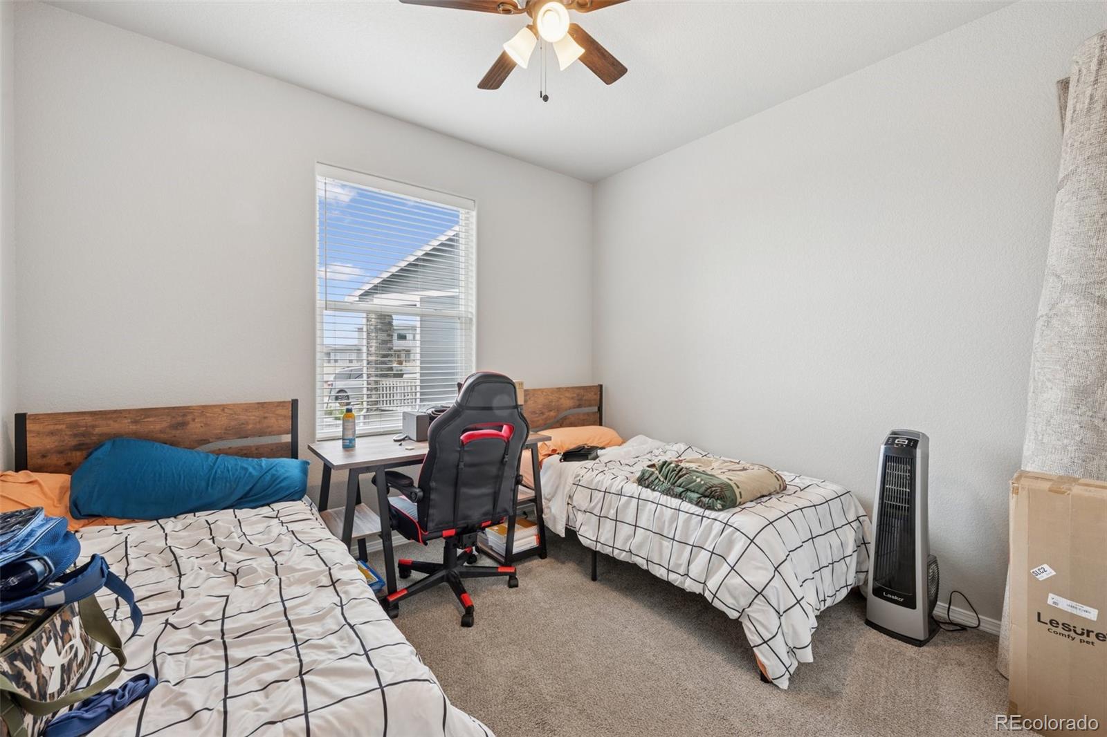12846 Granite Ridge Drive Peyton, CO 80831 - Photo 20 of 32 a bedroom with a bed and a window