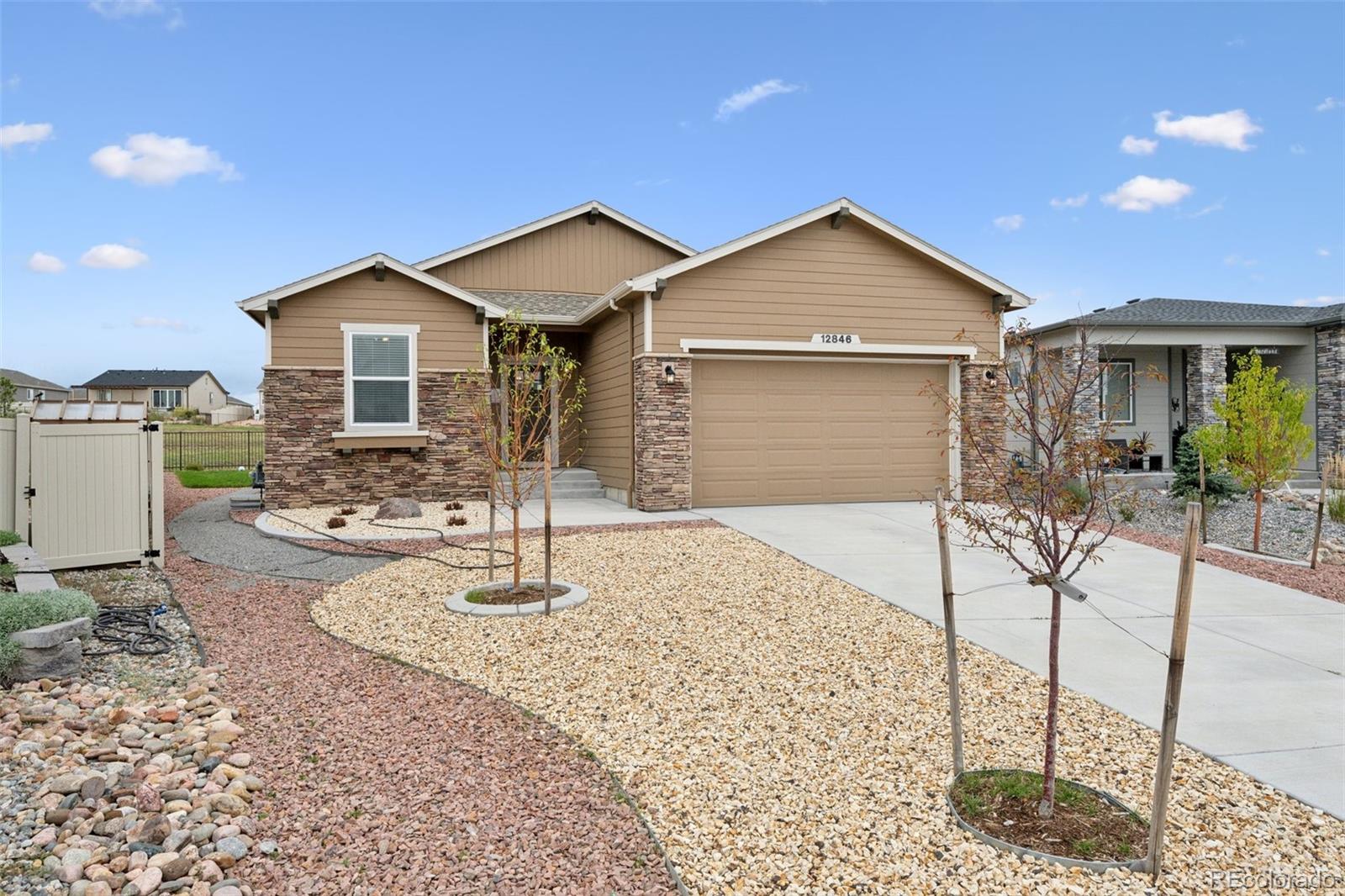 12846 Granite Ridge Drive Peyton, CO 80831 - Photo 2 of 32 a front view of a house with garden