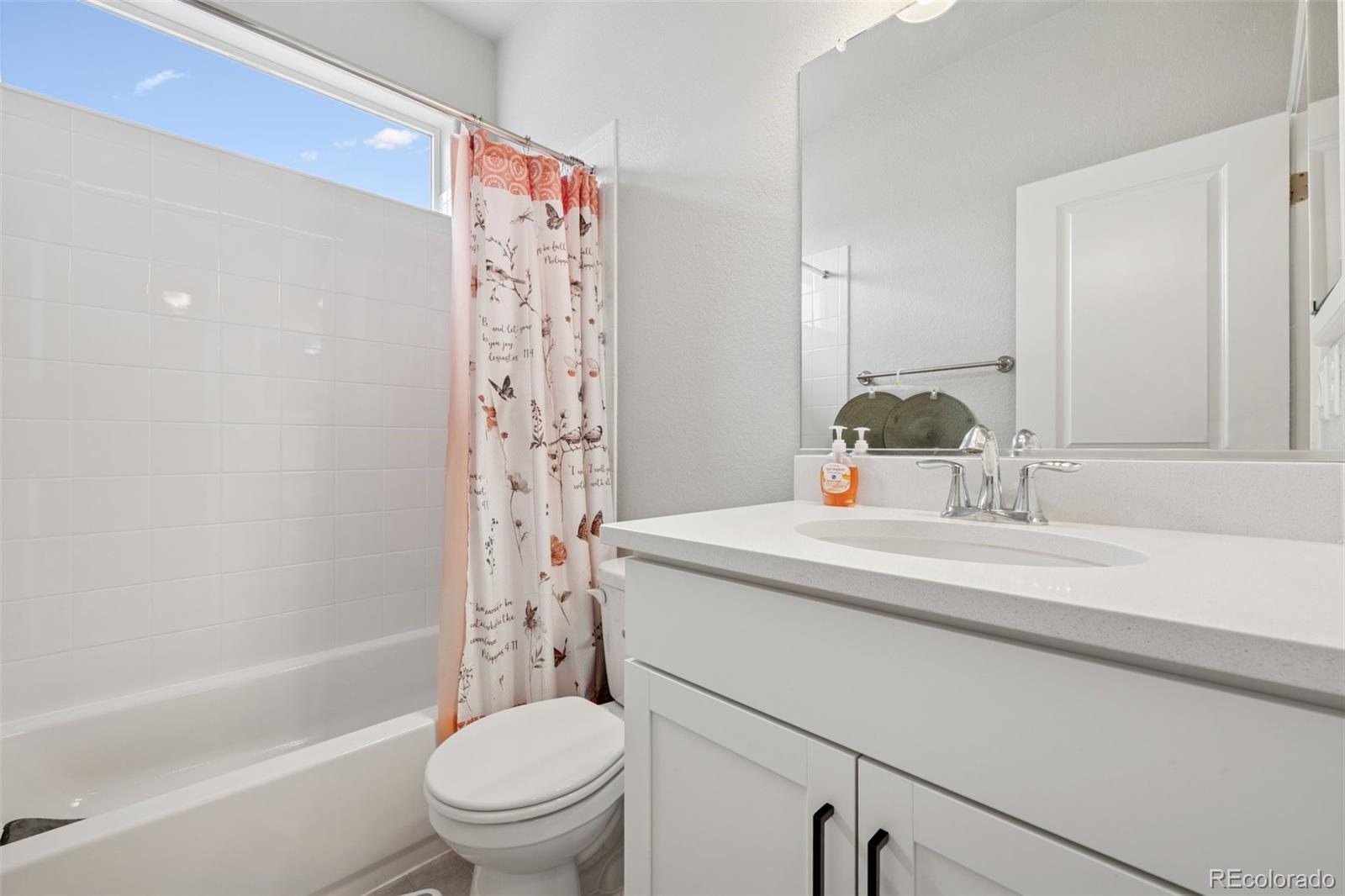 12846 Granite Ridge Drive Peyton, CO 80831 - Photo 22 of 32 a bathroom with a sink a toilet and shower