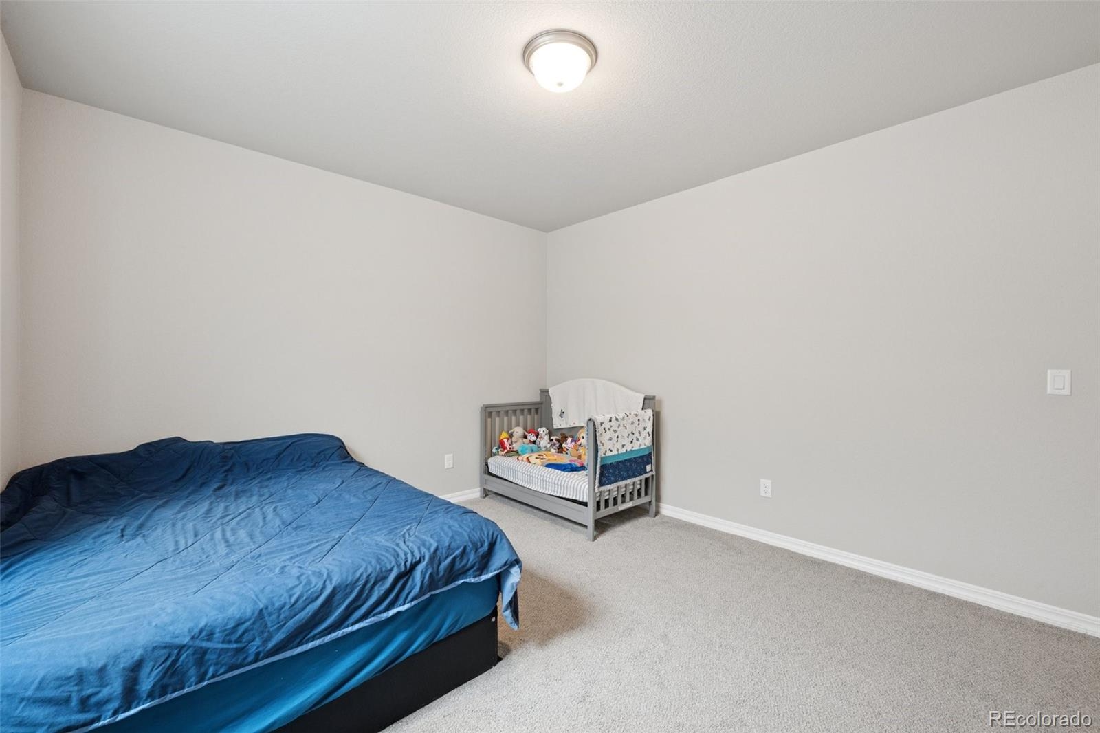 12846 Granite Ridge Drive Peyton, CO 80831 - Photo 26 of 32 a bedroom with a bed and window