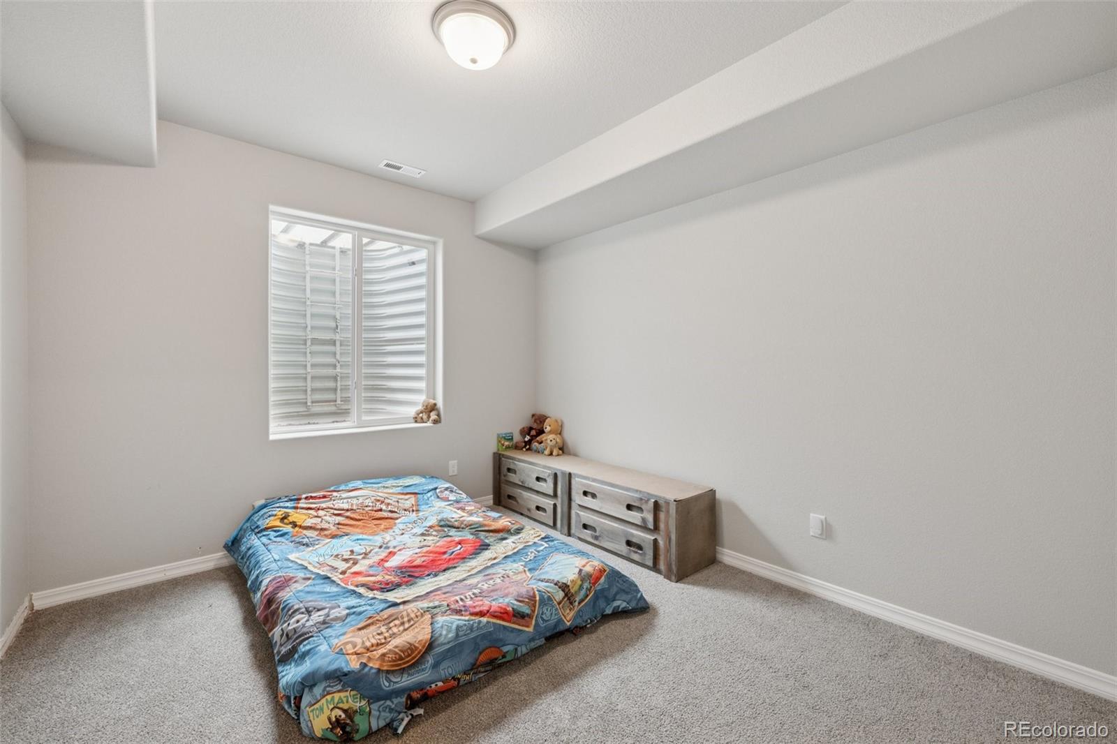 12846 Granite Ridge Drive Peyton, CO 80831 - Photo 27 of 32 a bedroom with bed and a window