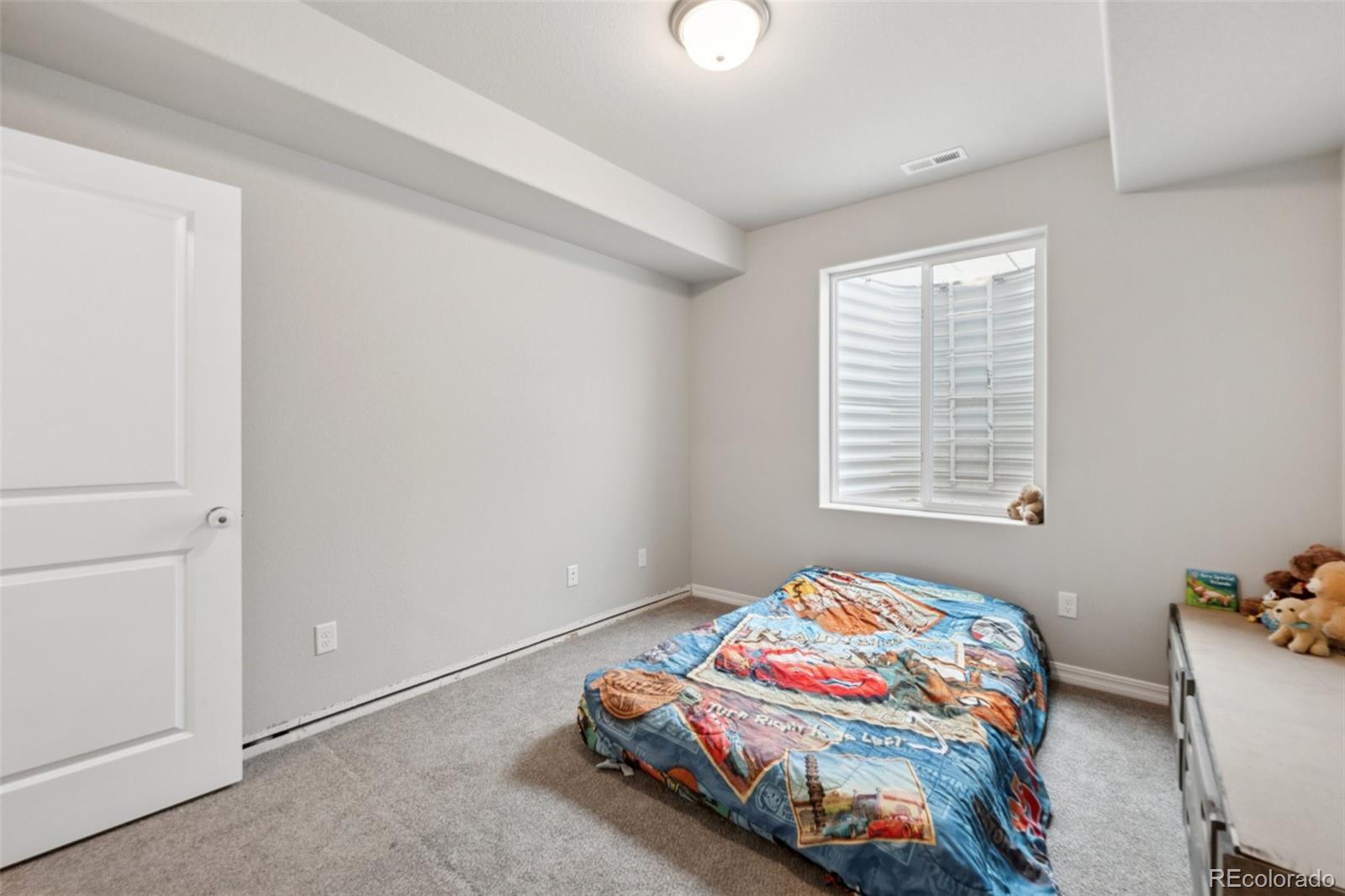 12846 Granite Ridge Drive Peyton, CO 80831 - Photo 28 of 32 a bedroom with bed and a window