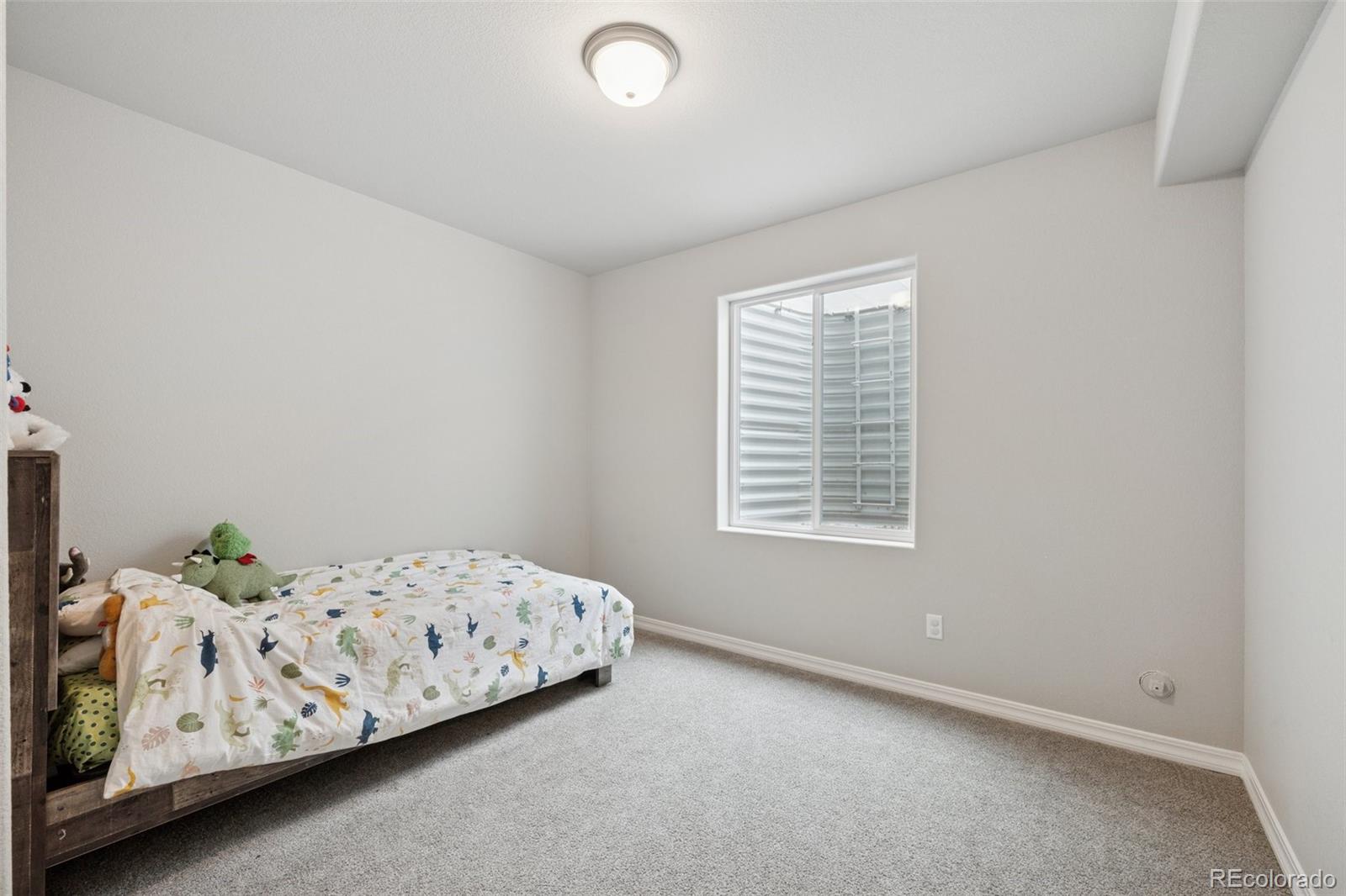 12846 Granite Ridge Drive Peyton, CO 80831 - Photo 29 of 32 a bedroom with a bed and a window