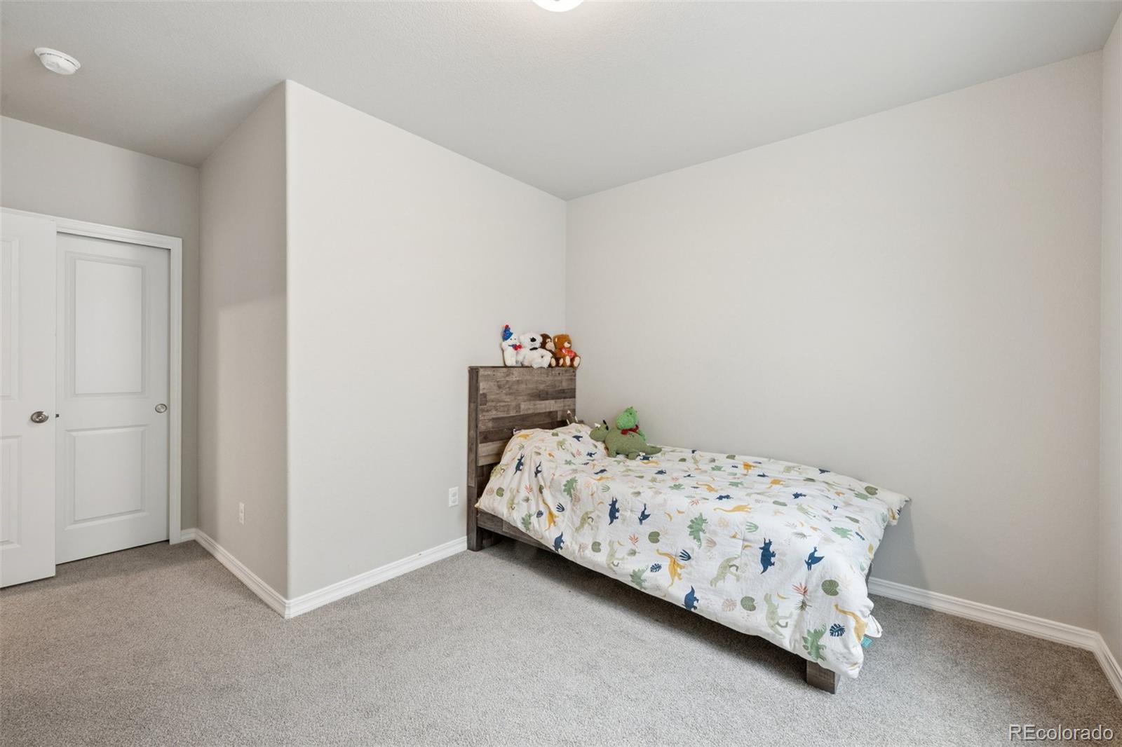 12846 Granite Ridge Drive Peyton, CO 80831 - Photo 30 of 32 a bedroom with a bed and a window