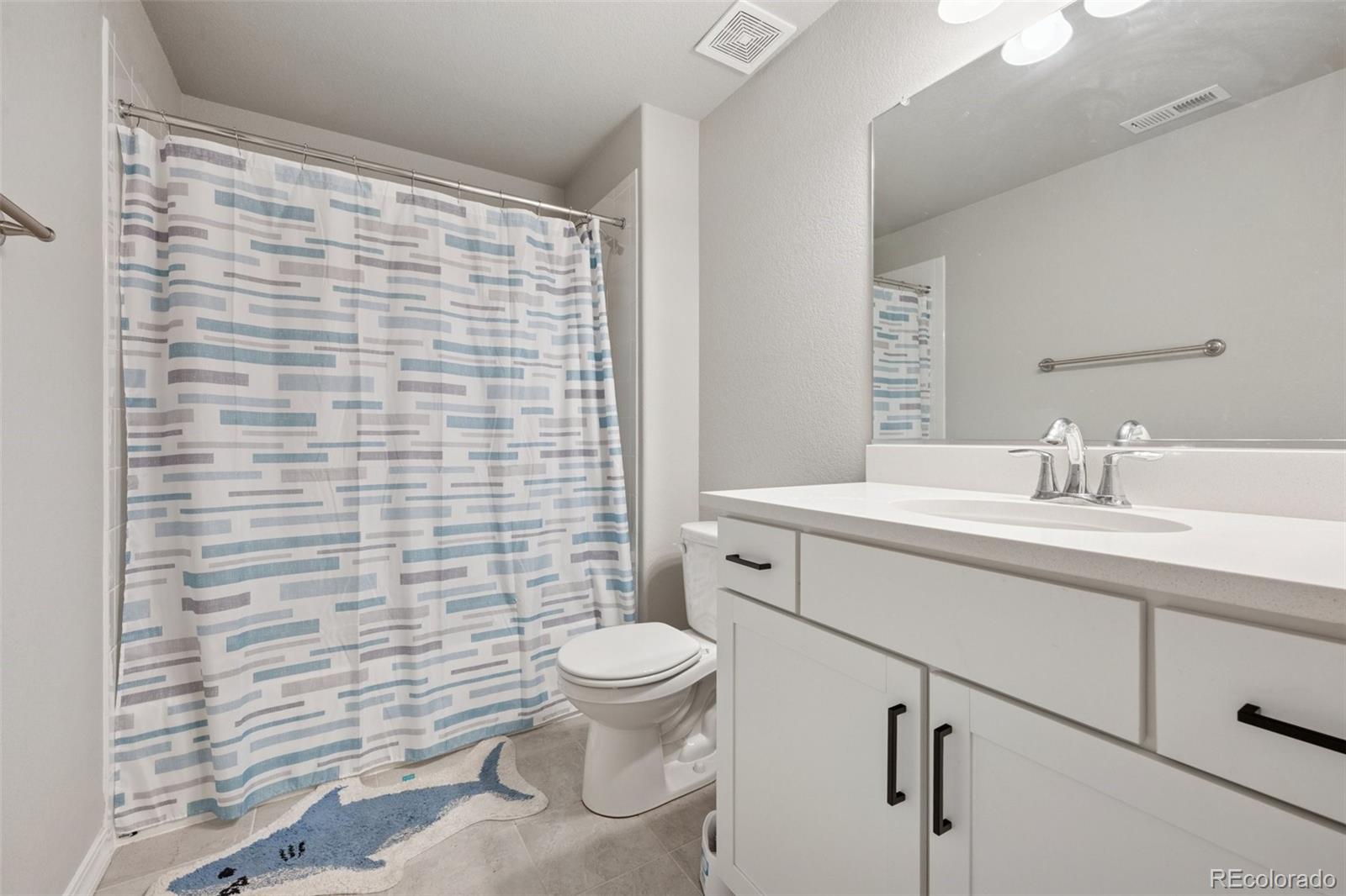12846 Granite Ridge Drive Peyton, CO 80831 - Photo 31 of 32 a bathroom with a sink a toilet and shower