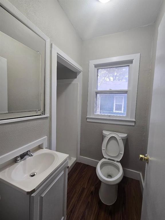 1126 West 6th Avenue Corsicana, TX 75110 - Photo 12 of 12 Bathroom featuring a textured wall, dark wood-type flooring, and vanity