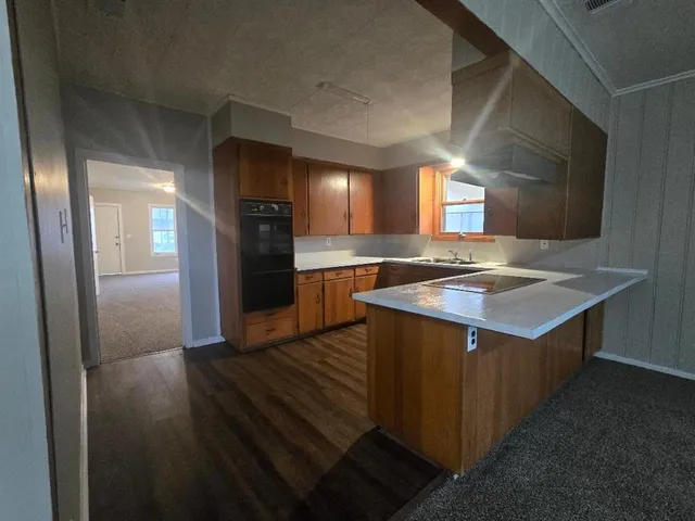 a kitchen with a sink and refrigerator