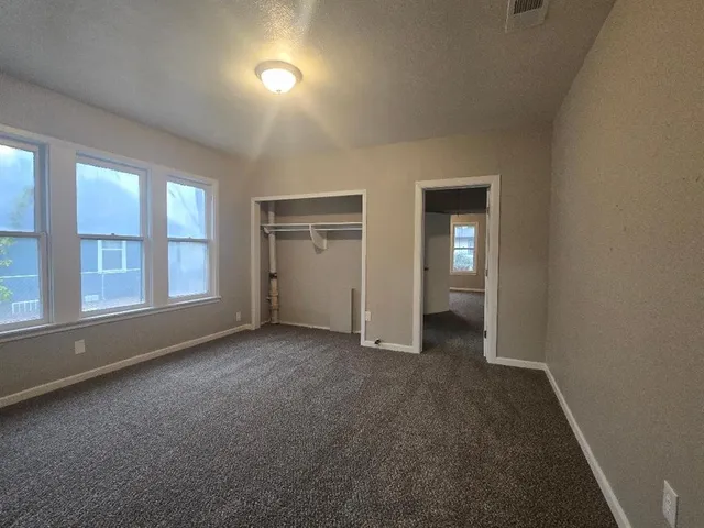 an empty room with windows and entrance