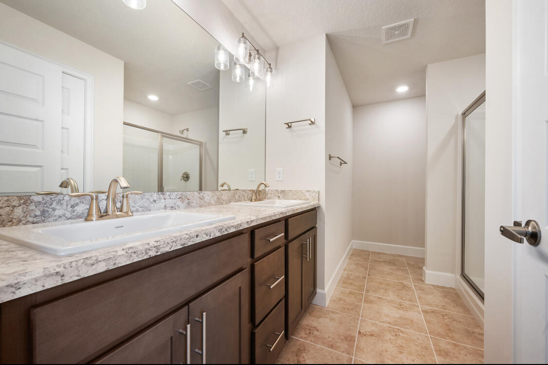 5536 Lugo Street Fort Pierce, FL 34951 - Photo 13 of 33 a bathroom with a granite countertop sink a mirror and a shower