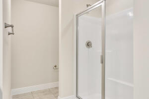 5536 Lugo Street Fort Pierce, FL 34951 - Photo 14 of 33 a bathroom with a glass shower door
