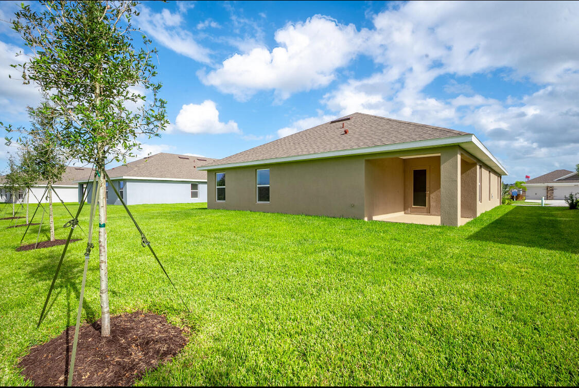 5536 Lugo Street Fort Pierce, FL 34951 - Photo 16 of 33 a aerial view of a house with yard and tree s
