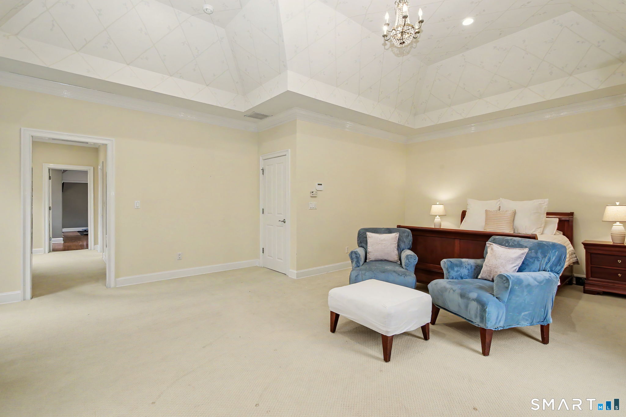 18 Brandon Circle Wilton, CT 06897 - Photo 23 of 40 a living room with furniture and a chandelier