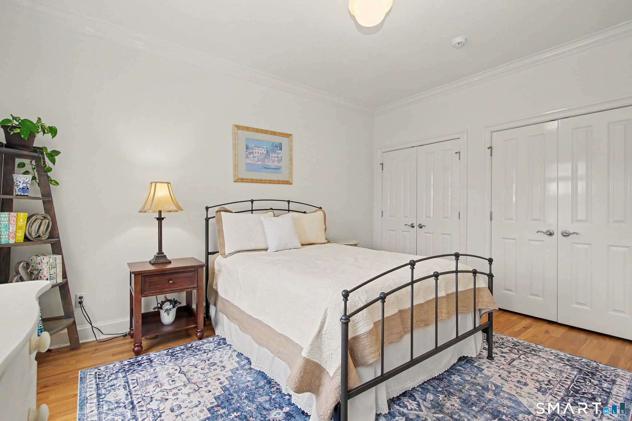 18 Brandon Circle Wilton, CT 06897 - Photo 31 of 40 a bedroom with a bed and a lamp on table
