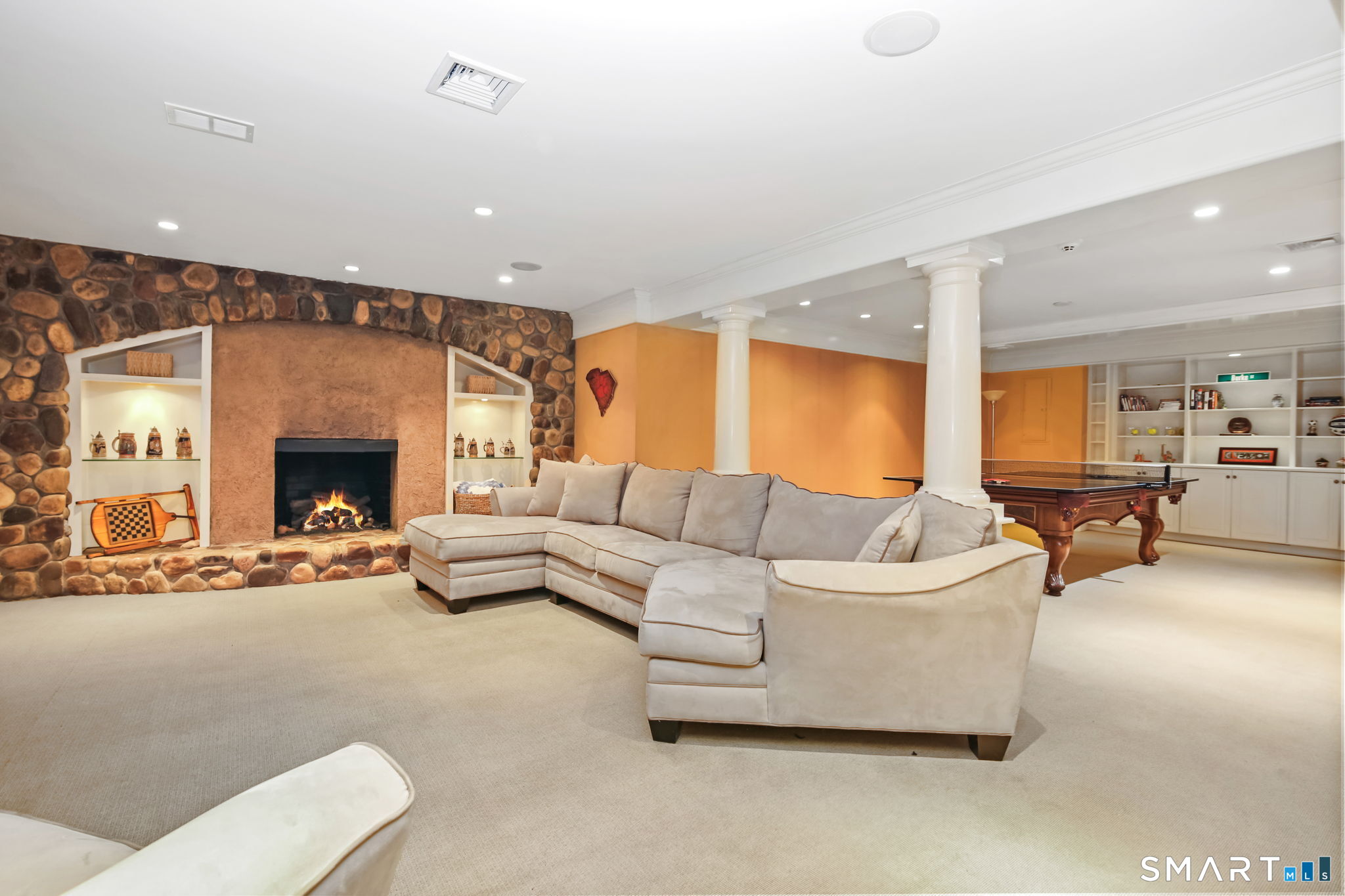 18 Brandon Circle Wilton, CT 06897 - Photo 35 of 40 a living room with furniture and a fireplace