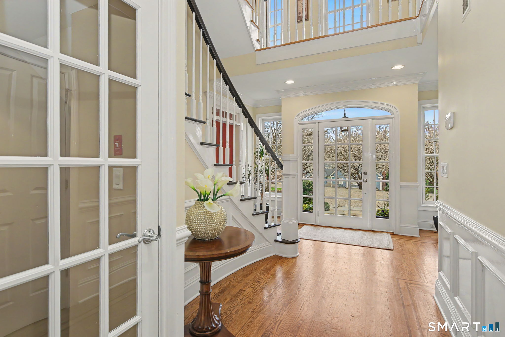 18 Brandon Circle Wilton, CT 06897 - Photo 9 of 40 a view of an entryway with wooden floor and windows