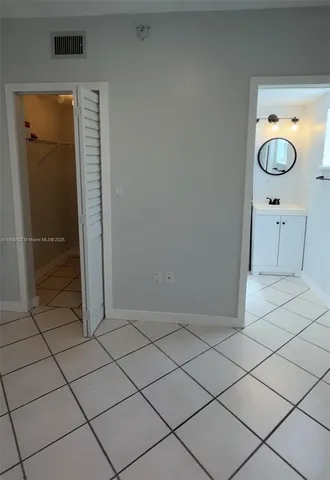a bathroom with a shower and a mirror