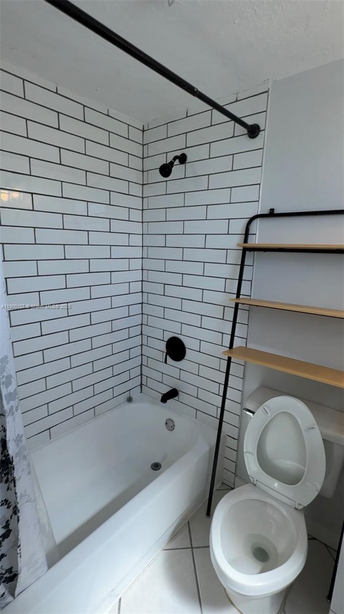 3051 Southwest 27th Avenue, Unit 402 Miami, FL 33133 - Photo 4 of 5 a bathroom with a toilet and a shower