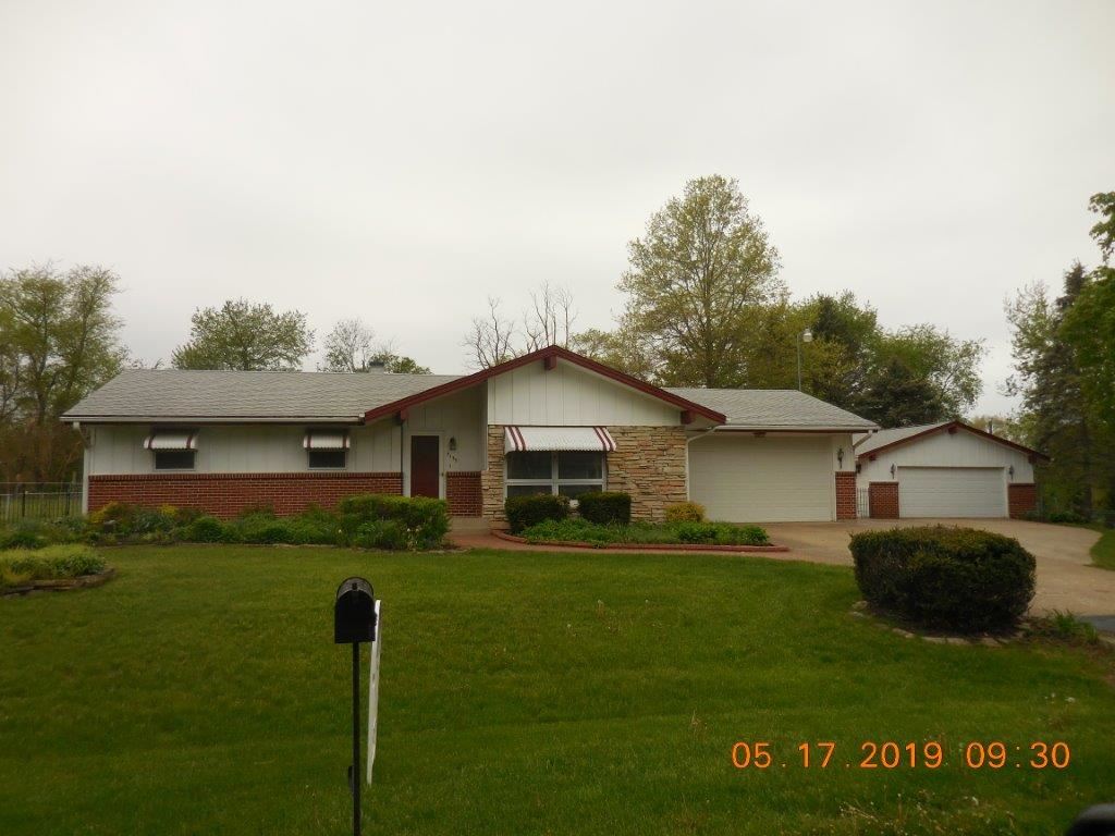 7135 Ralph Road Rockford, IL 61109 - Photo 1 of 16 a front view of a house with a garden