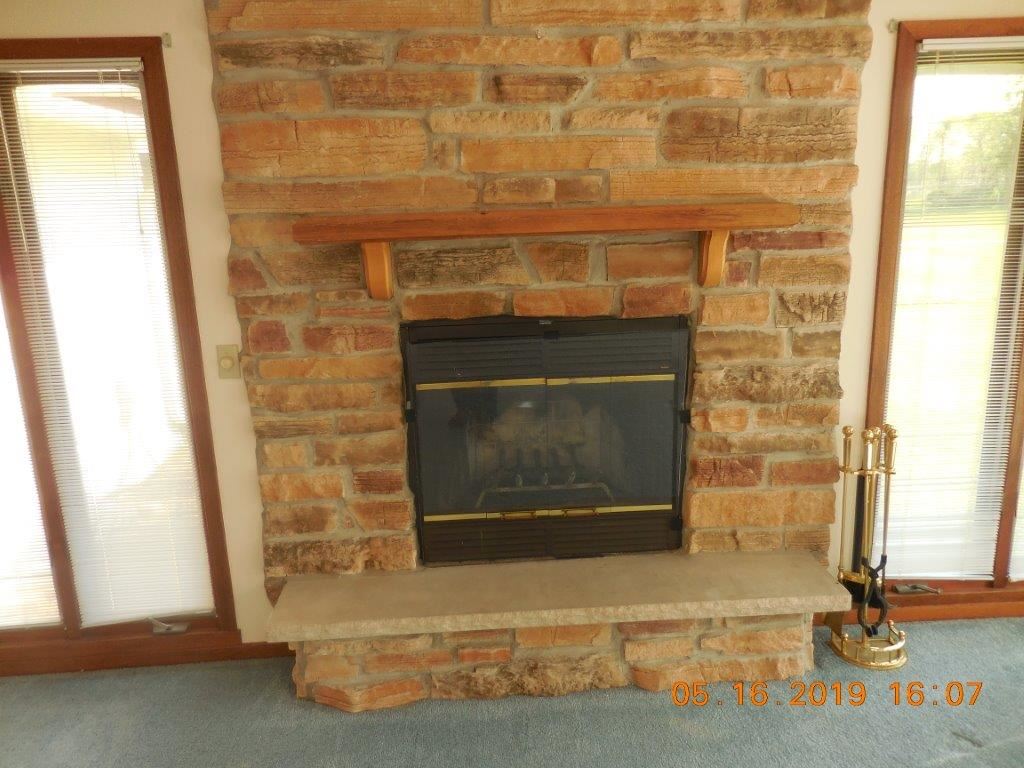 7135 Ralph Road Rockford, IL 61109 - Photo 15 of 16 a living room with a fireplace