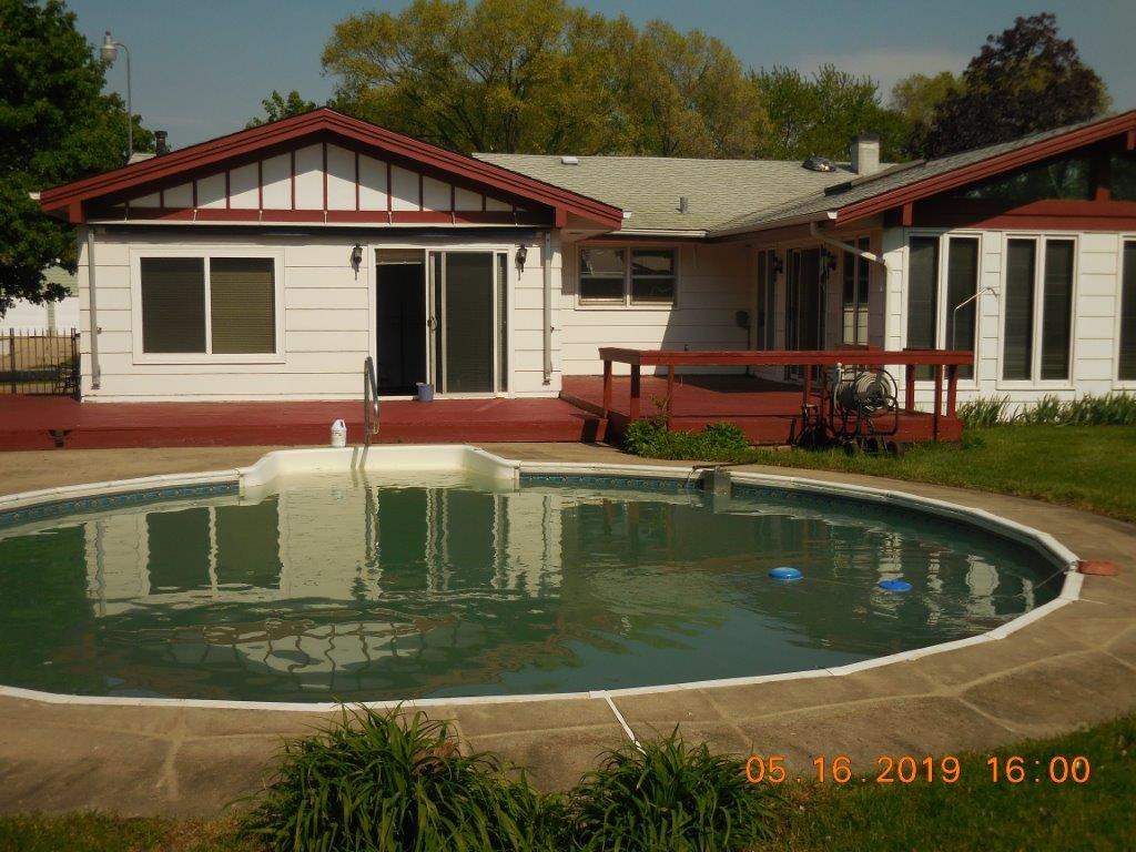 7135 Ralph Road Rockford, IL 61109 - Photo 5 of 16 a view of a house with swimming pool