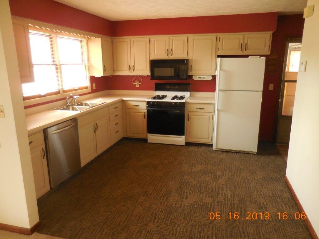 7135 Ralph Road Rockford, IL 61109 - Photo 8 of 16 a kitchen with a refrigerator sink and cabinets