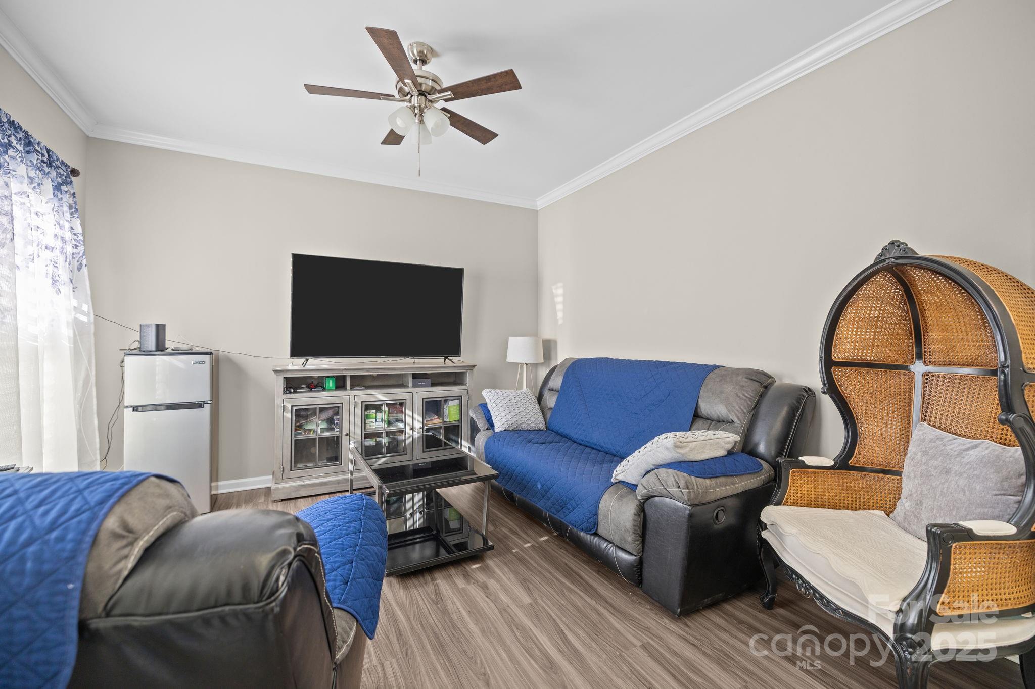 6416 Baltray Road Charlotte, NC 28278 - Photo 14 of 34 a living room with furniture a flat screen tv and a window