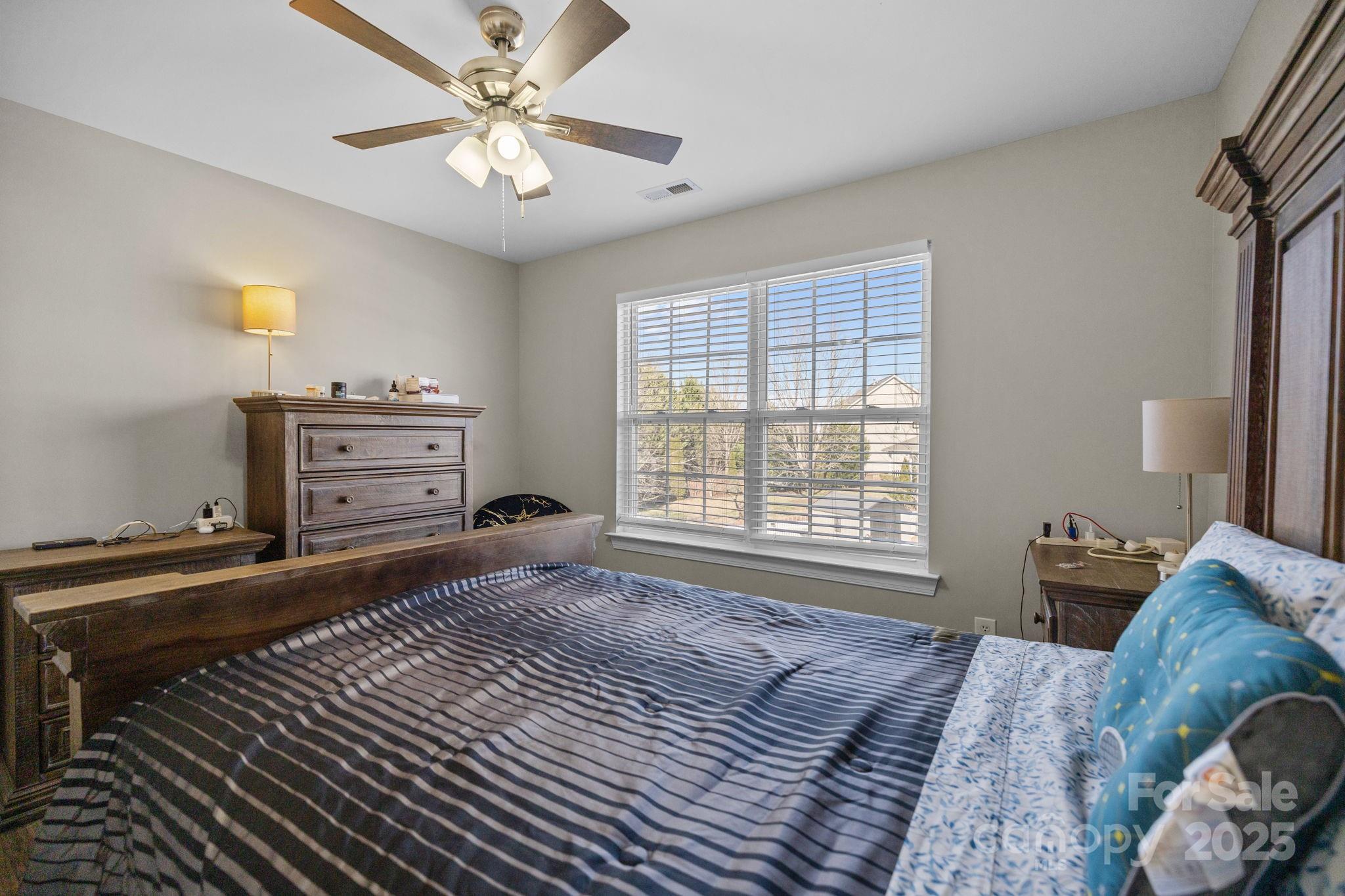 6416 Baltray Road Charlotte, NC 28278 - Photo 26 of 34 a bedroom with a bed and a chandelier