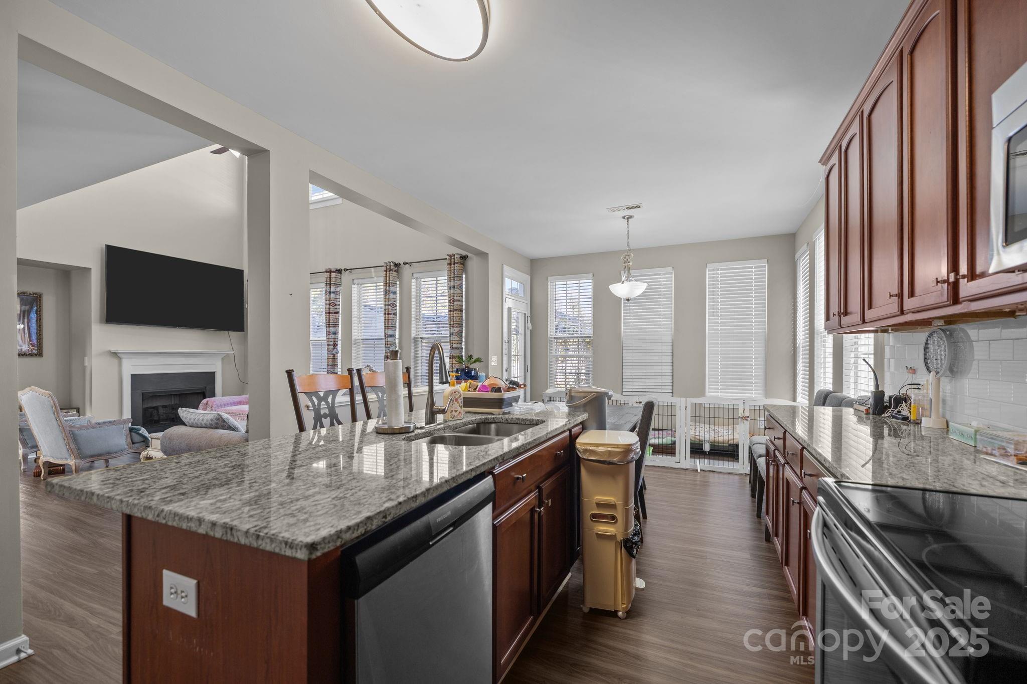 6416 Baltray Road Charlotte, NC 28278 - Photo 8 of 34 a kitchen with sink stove top oven dining table and chairs
