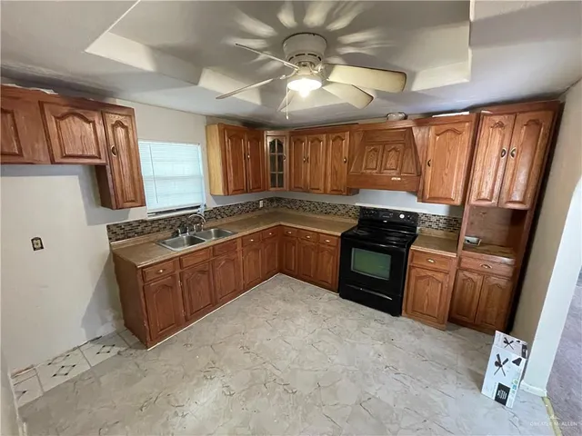 a kitchen with stainless steel appliances granite countertop a stove sink and cabinets