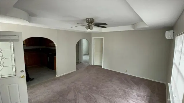 an empty room with windows and cabinet