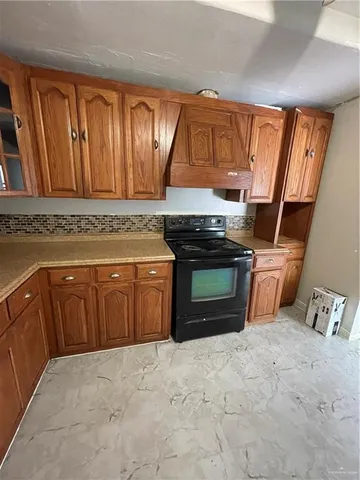 a kitchen with stainless steel appliances granite countertop a stove top oven and sink