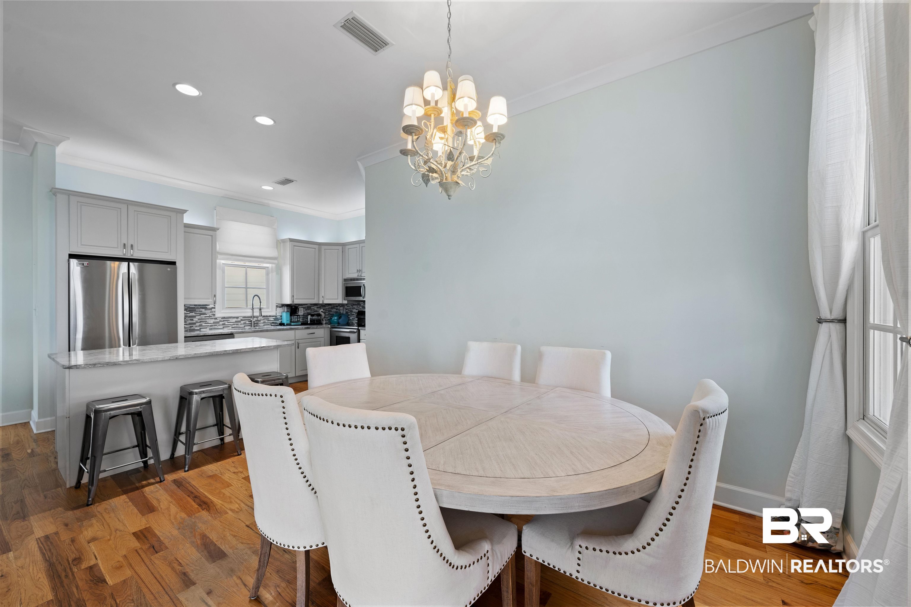 3434 Mariner Circle Orange Beach, AL 36561 - Photo 22 of 38 Dining room featuring light hardwood / wood-style flooring, sink, a chandelier, and ornamental molding