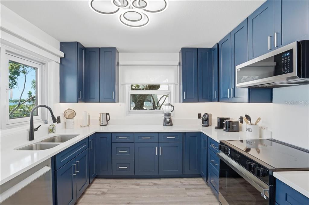 3481 Bayou Sound Longboat Key, FL 34228 - Photo 20 of 79 a kitchen with stainless steel appliances granite countertop a sink stove and cabinets