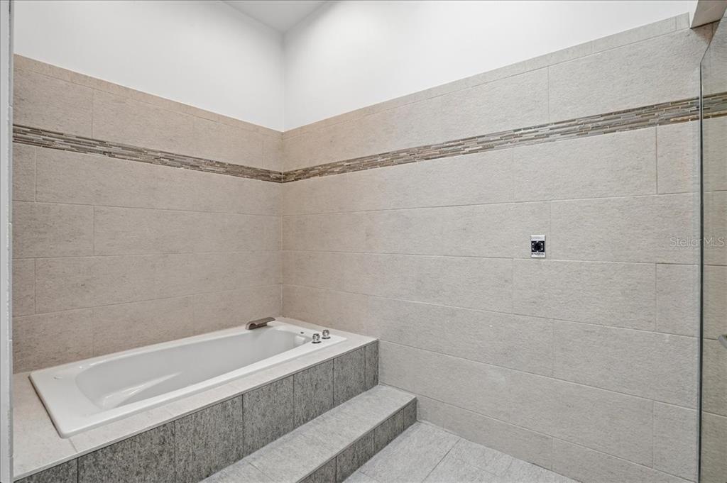 3481 Bayou Sound Longboat Key, FL 34228 - Photo 31 of 79 a bathroom with a bathtub and shower
