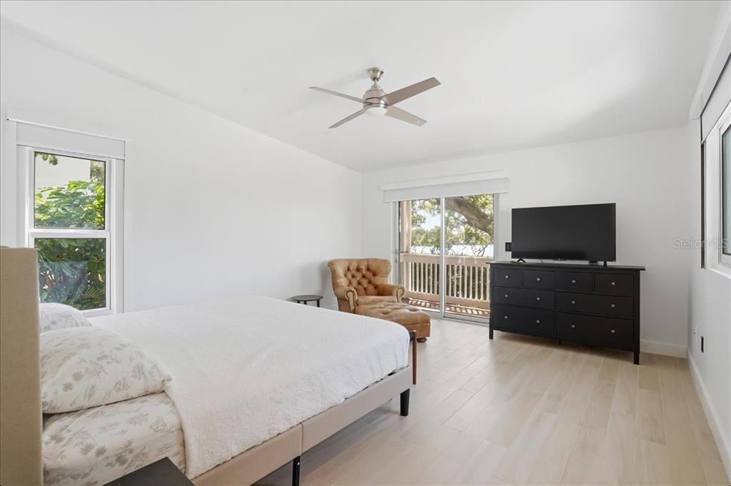 3481 Bayou Sound Longboat Key, FL 34228 - Photo 36 of 79 a bedroom with a bed and a flat screen tv
