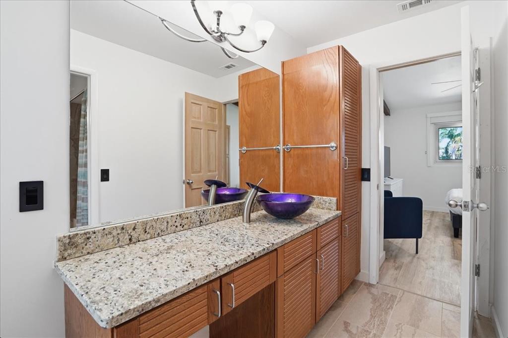 3481 Bayou Sound Longboat Key, FL 34228 - Photo 43 of 79 a bathroom with a granite countertop sink and a mirror