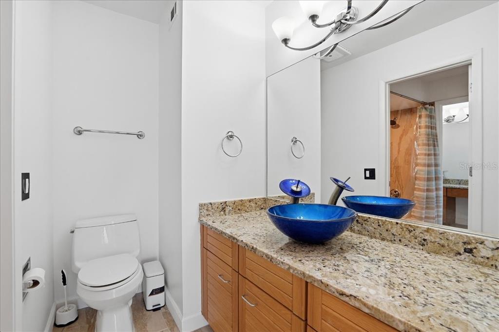 3481 Bayou Sound Longboat Key, FL 34228 - Photo 45 of 79 a bathroom with a granite countertop toilet sink and mirror