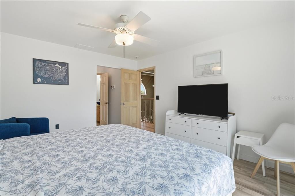 3481 Bayou Sound Longboat Key, FL 34228 - Photo 49 of 79 a bedroom with a bed and a flat screen tv