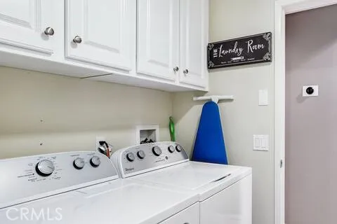 a large bed sitting in a bedroom next to a window