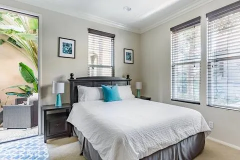 a bedroom with a bed and window