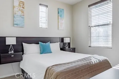 a bedroom with a bed and a television