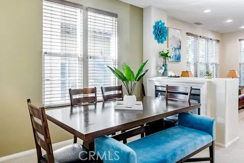 a view of a dining room with furniture and window